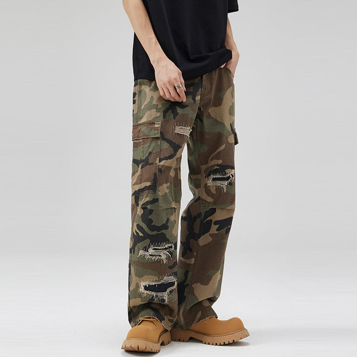 Men's loose cargo pants in camouflage look with deliberately ripped details and large flap pockets Mune Fashion