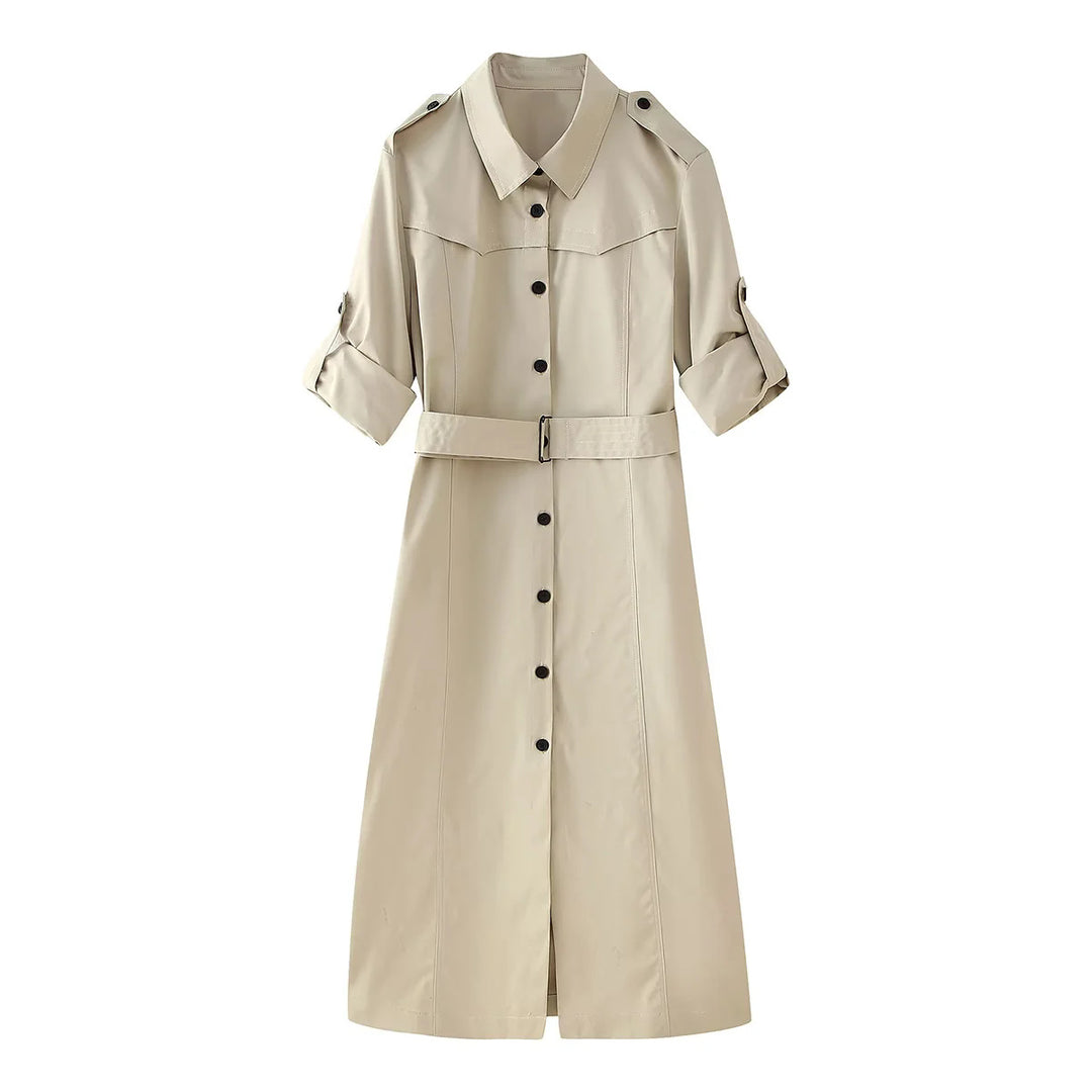 Women's longer tailored trench coat with waist belt, shoulder epaulettes, and continuous button placket Mune Fashion