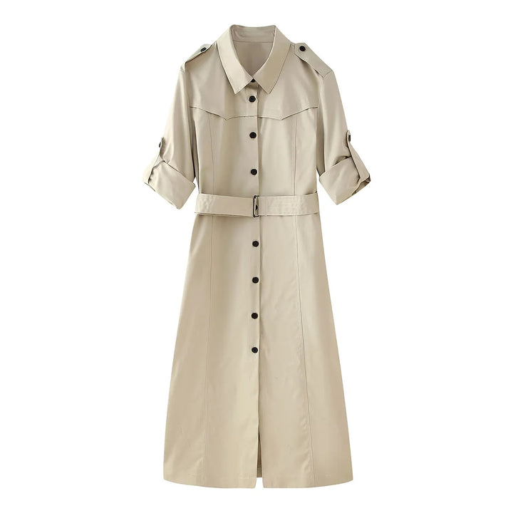 Women's longer tailored trench coat with waist belt, shoulder epaulettes, and continuous button placket Mune Fashion