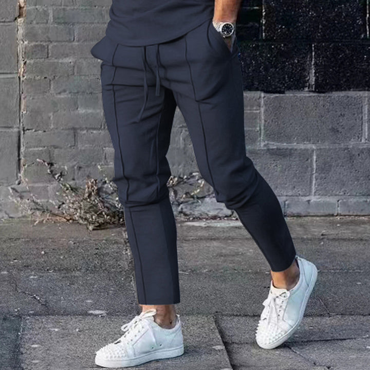 Men's Slim Tapered Jogging Pants with decorative stitching, elastic drawstring, and narrow ankle cuffs Mune Fashion
