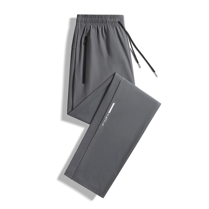 Men's sporty jogging pants with elastic waistband and practical zip pockets Mune Fashion
