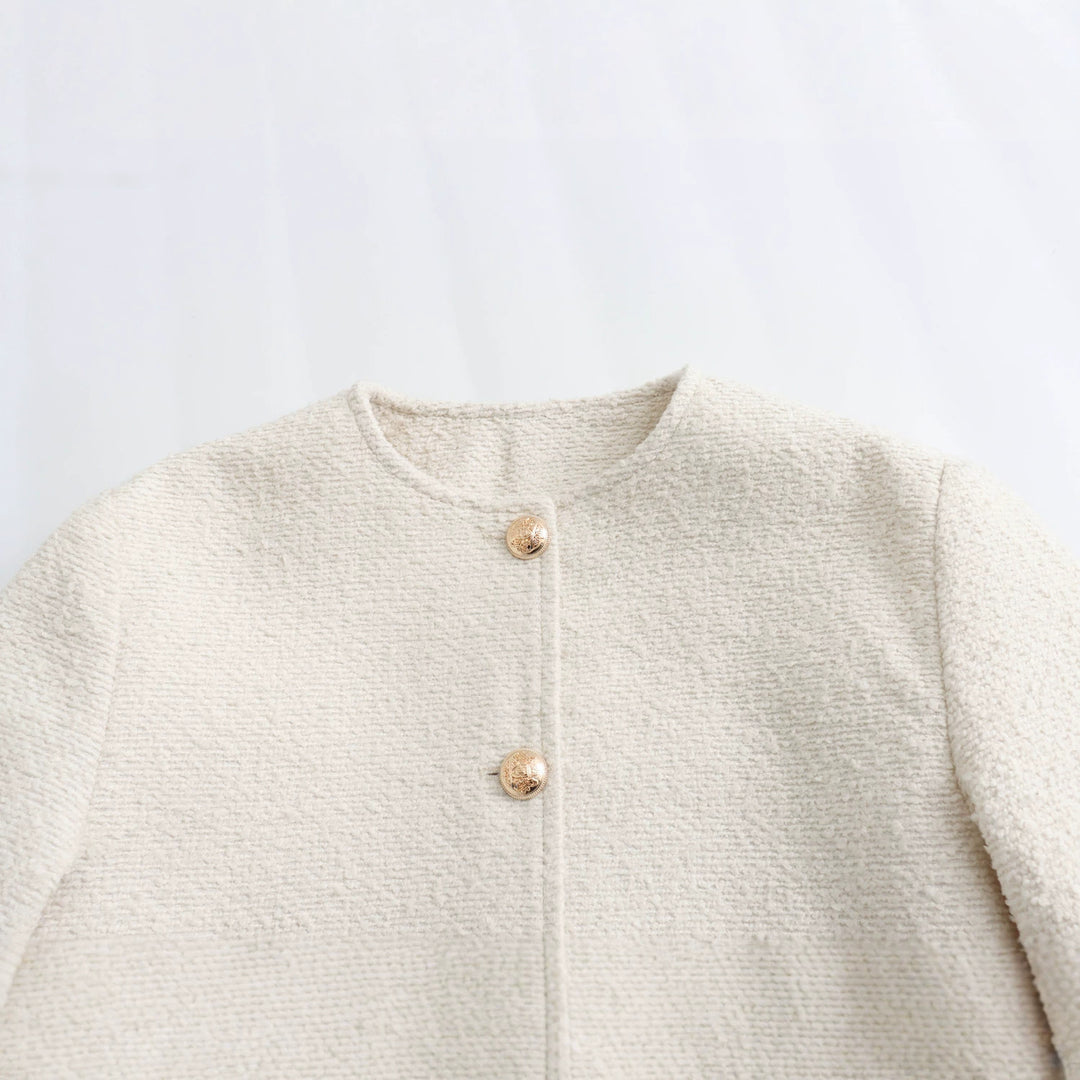 Women's elegant bouclé cropped jacket with round neckline, gold button details, and patch waist pockets Mune Fashion