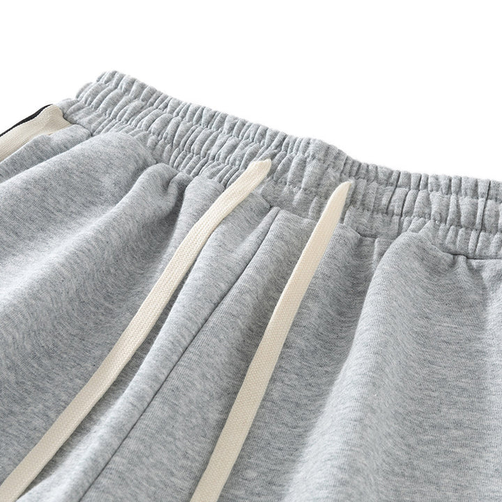 Men's loose-fitting joggers with elastic waistband, drawstring, and contrasting side stripes Mune Fashion