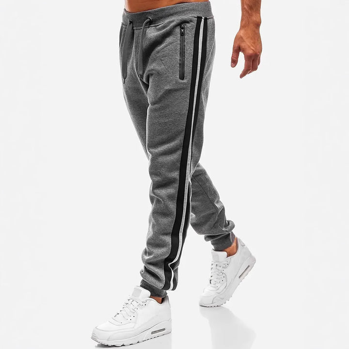 Men's narrow tapered fleece jogging pants with two-tone side piping and water-repellent zip pockets Mune Fashion