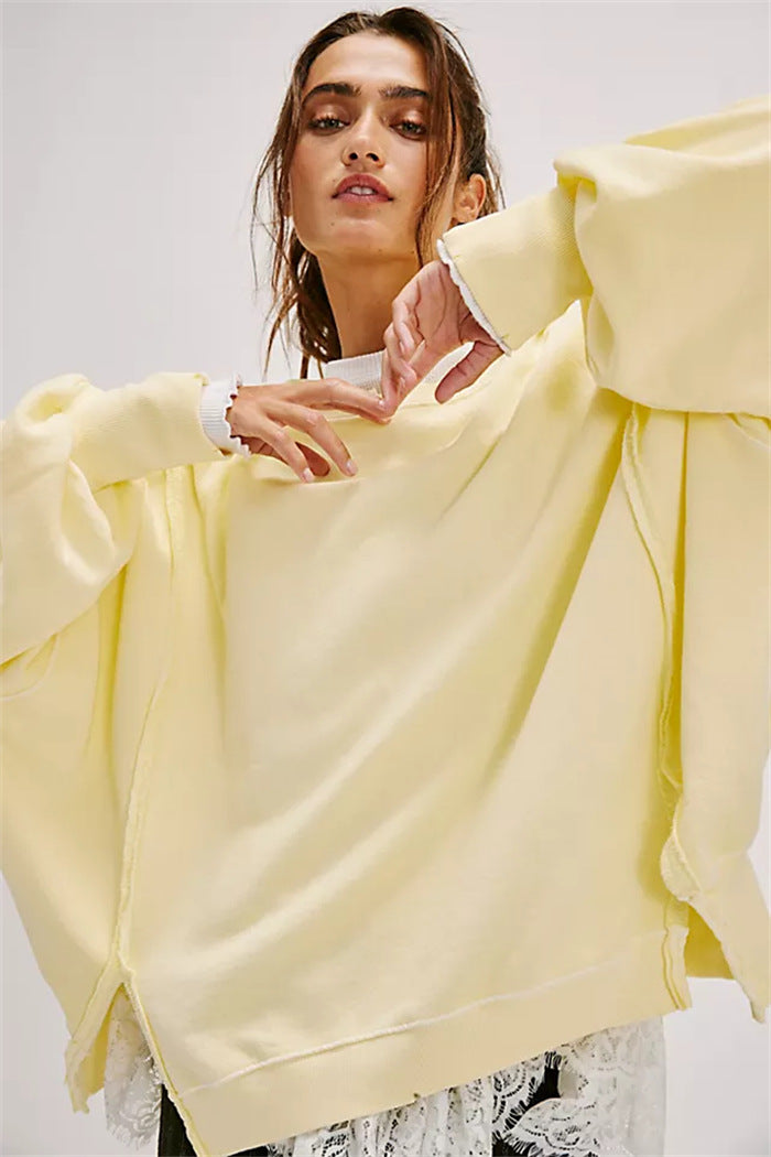 Women's oversized sweatshirt with balloon sleeves, open seam stitches, and side slits Mune Fashion