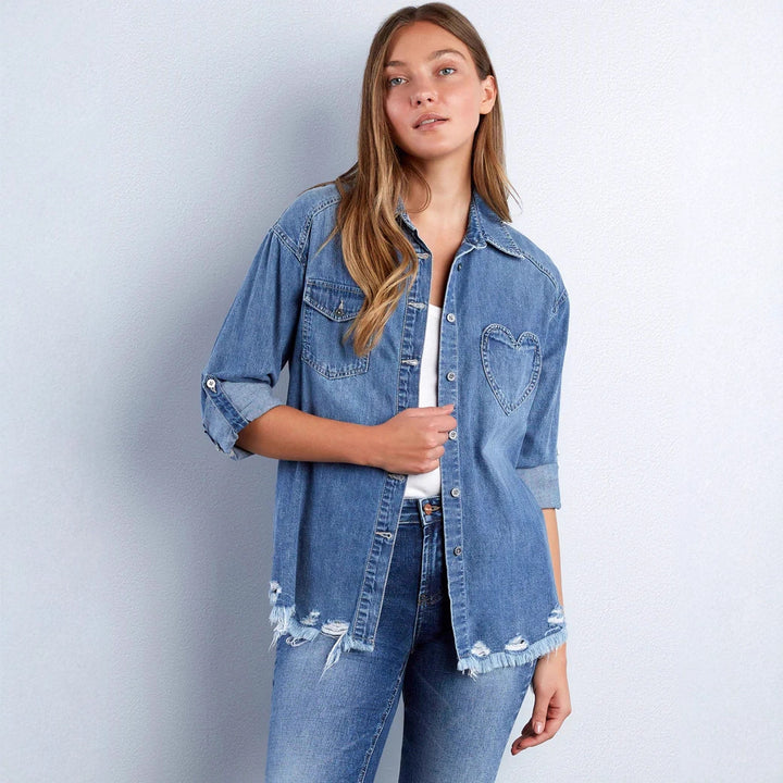 Women's casual denim shirt jacket oversized with patch chest pockets, heart embroidery detail, and frayed hem Mune Fashion