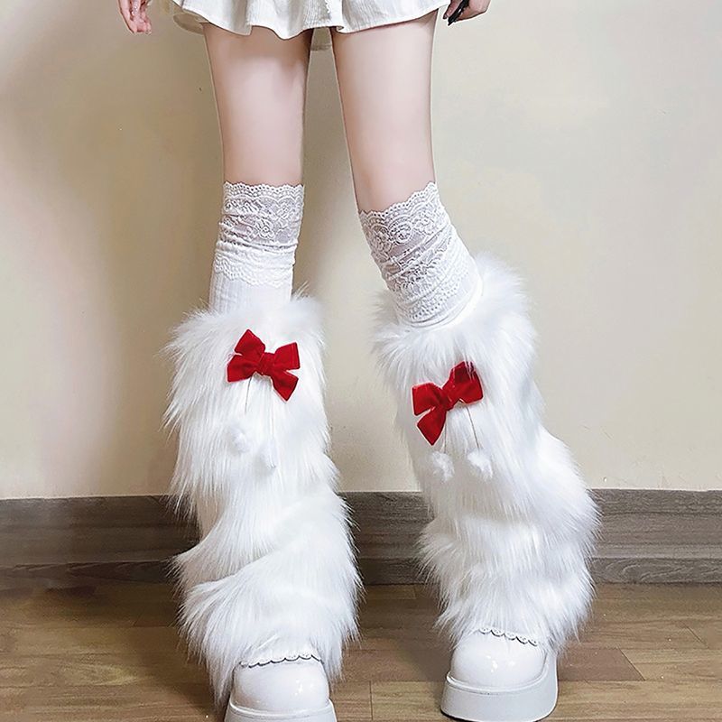 Ladies cozy boot cuffs made of faux fur with bow appliqué and pompons Mune Fashion