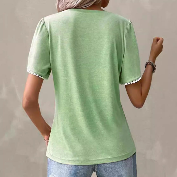 Women's round neck shirt with decorative pleated front, flutter sleeves and pompom trim Mune Fashion