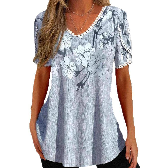 Women's flowing V-neck tunic top with floral print pompom trim and A-line cut Mune Fashion