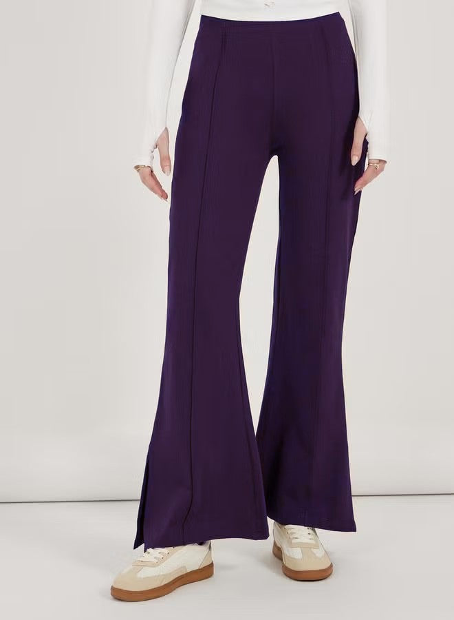 Women’s flared pants with high waist, continuous crease and side hem slit Drune