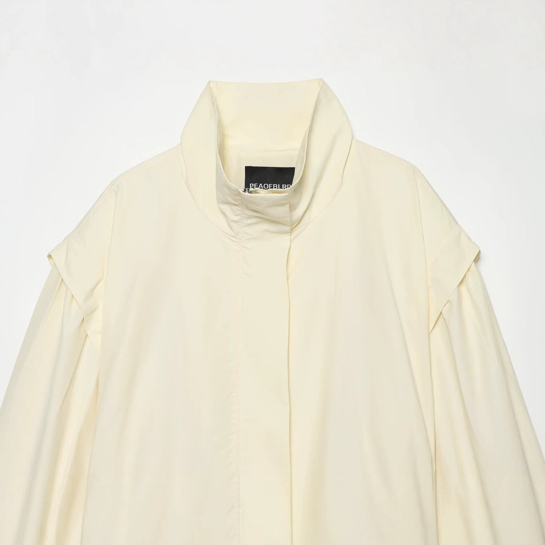 Women's short jacket made of flowing fabric with waist belt and cape shoulder drape