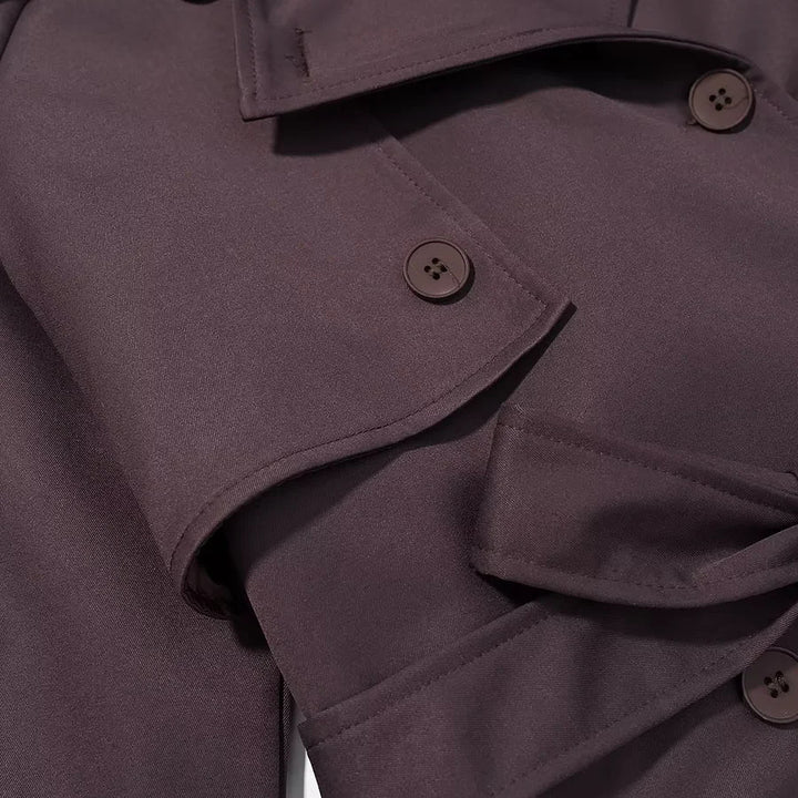 Women's longer double-breasted trench coat with waist belt, epaulettes, and storm flap Mune Fashion