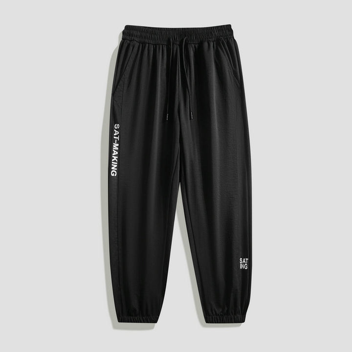 Men's sporty jogging pants with elastic waistband and zippered pockets Mune Fashion