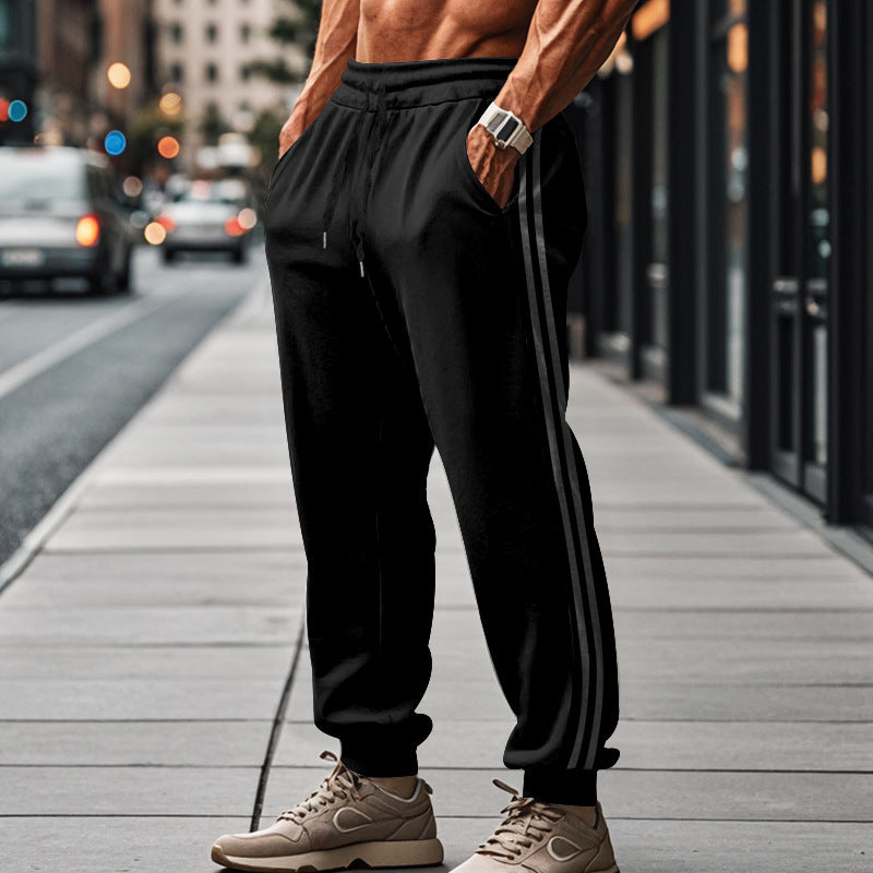 Men's sporty jogging pants with side contrast stripes, elastic drawstring waistband, and ribbed leg endings Mune Fashion