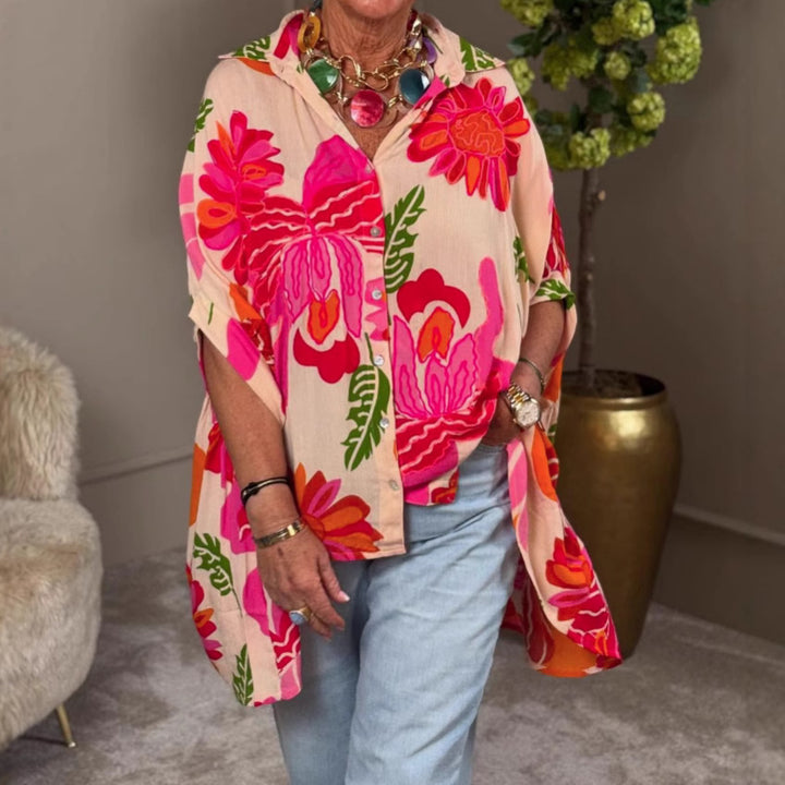Women's airy oversized resort-style shirt blouse with large floral print and asymmetrical scalloped hem Mune Fashion