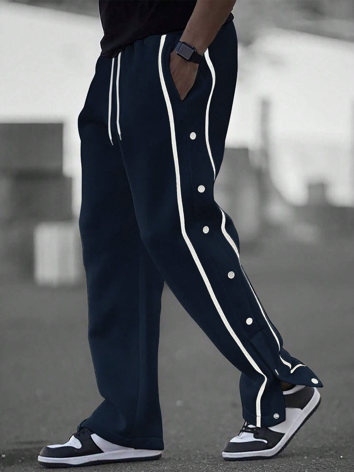 Men's casual training pants with side snap button placket, elastic waistband and contrasting piping Mune Fashion