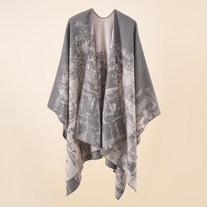 Women's wool blend cape with graphic jacquard, open kimono fall, and soft draping.