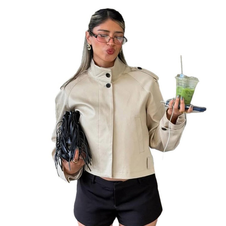 Women's short boxy trench-style jacket with high stand-up collar and shoulder flaps Mune Fashion