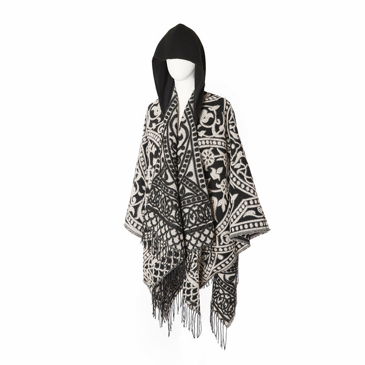 Women’s hooded cape poncho made of wool blend with jacquard pattern, fringes and oversized drape.