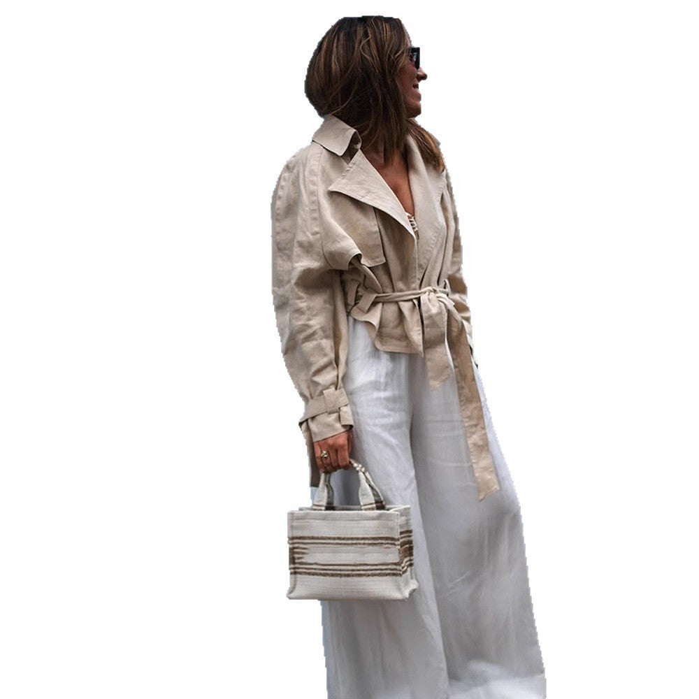 Women’s short trench coat with waist knot detail, cape sleeves, and boxy cropped cut Mune Fashion