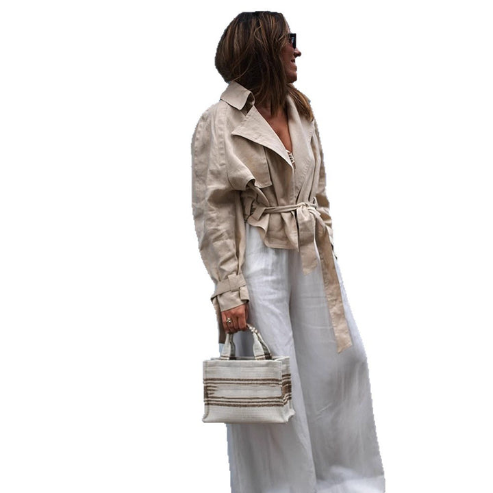 Women’s short trench coat with waist knot detail, cape sleeves, and boxy cropped cut Mune Fashion