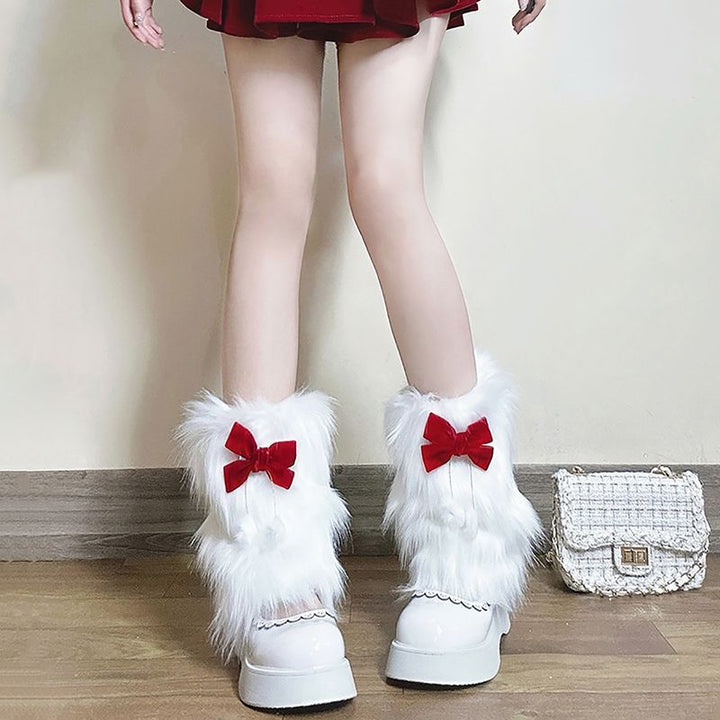 Ladies cozy boot cuffs made of faux fur with bow appliqué and pompons Mune Fashion
