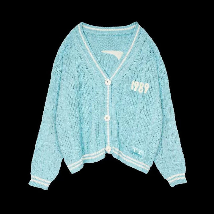 Women’s cropped cardigan with V-neck, contrast piping and oversized sleeves Mune Fashion
