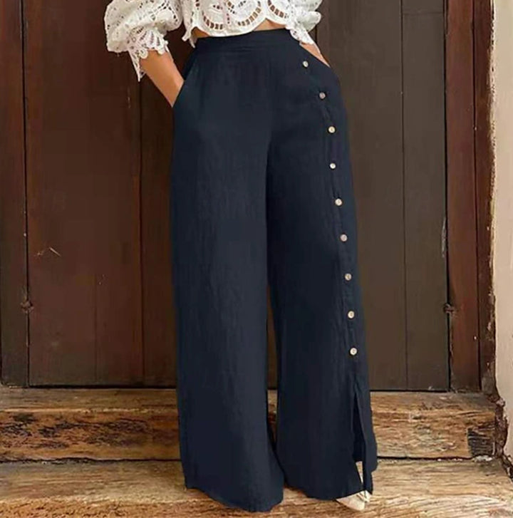 Women's high-waisted linen trousers with a side decorative button placket, side pockets, and wide leg cut Mune Fashion