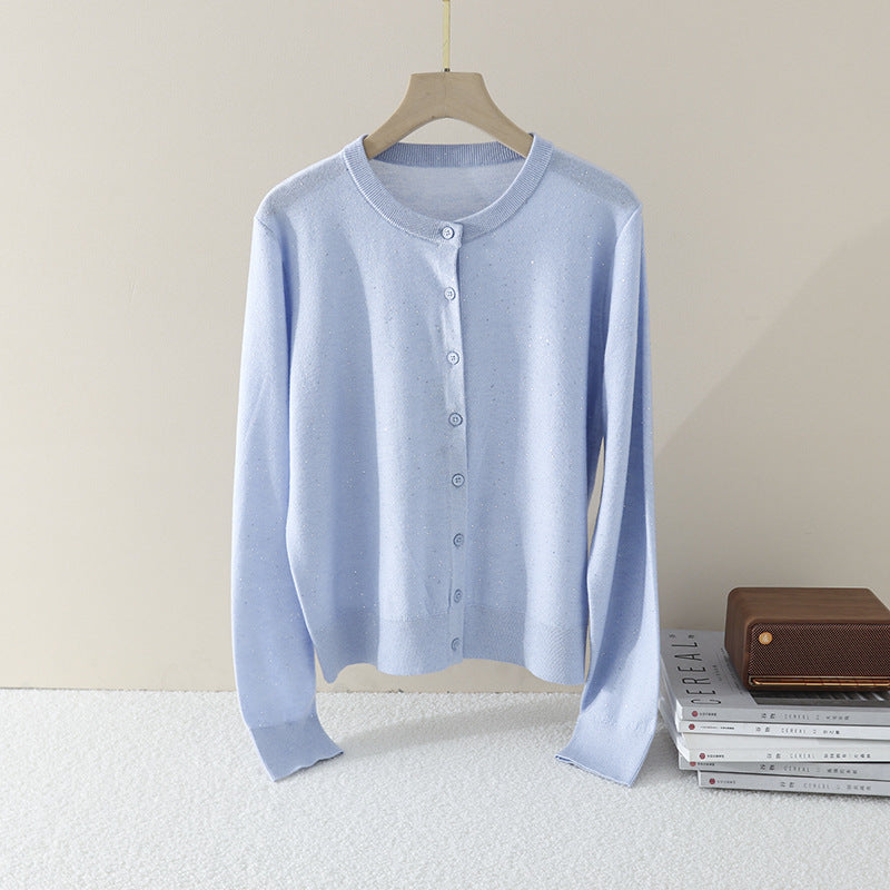 Women's fine round neck cardigan made of lightweight fine knit with pearl button placket and subtle glitter effect.