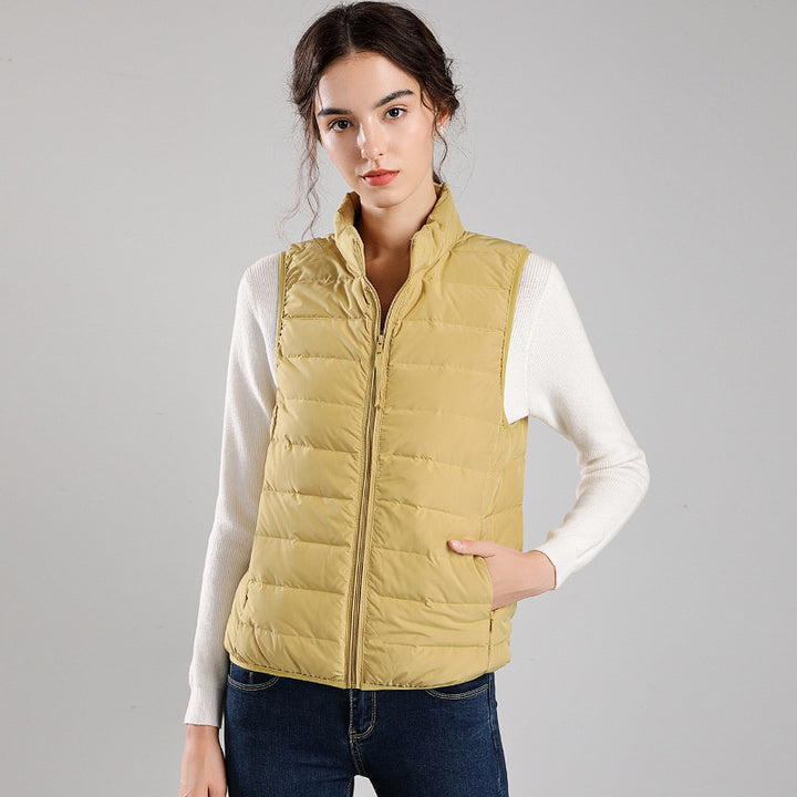 Women's packable quilted vest with flat down look, stand-up collar and side slip pockets Mune Fashion