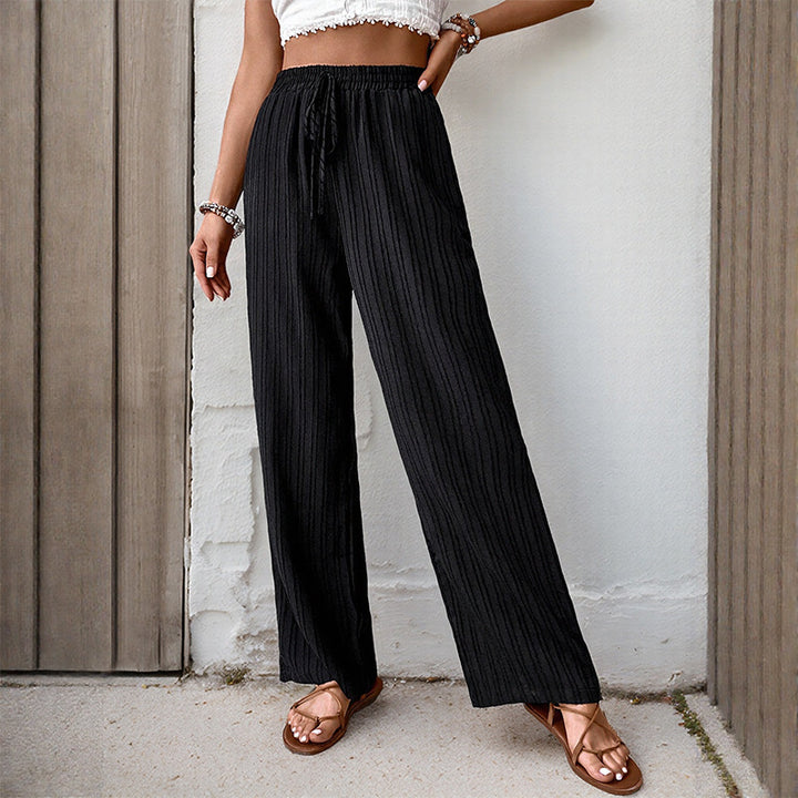 Women's loose summer trousers made from lightweight crinkle fabric with elastic waistband and drawstring.