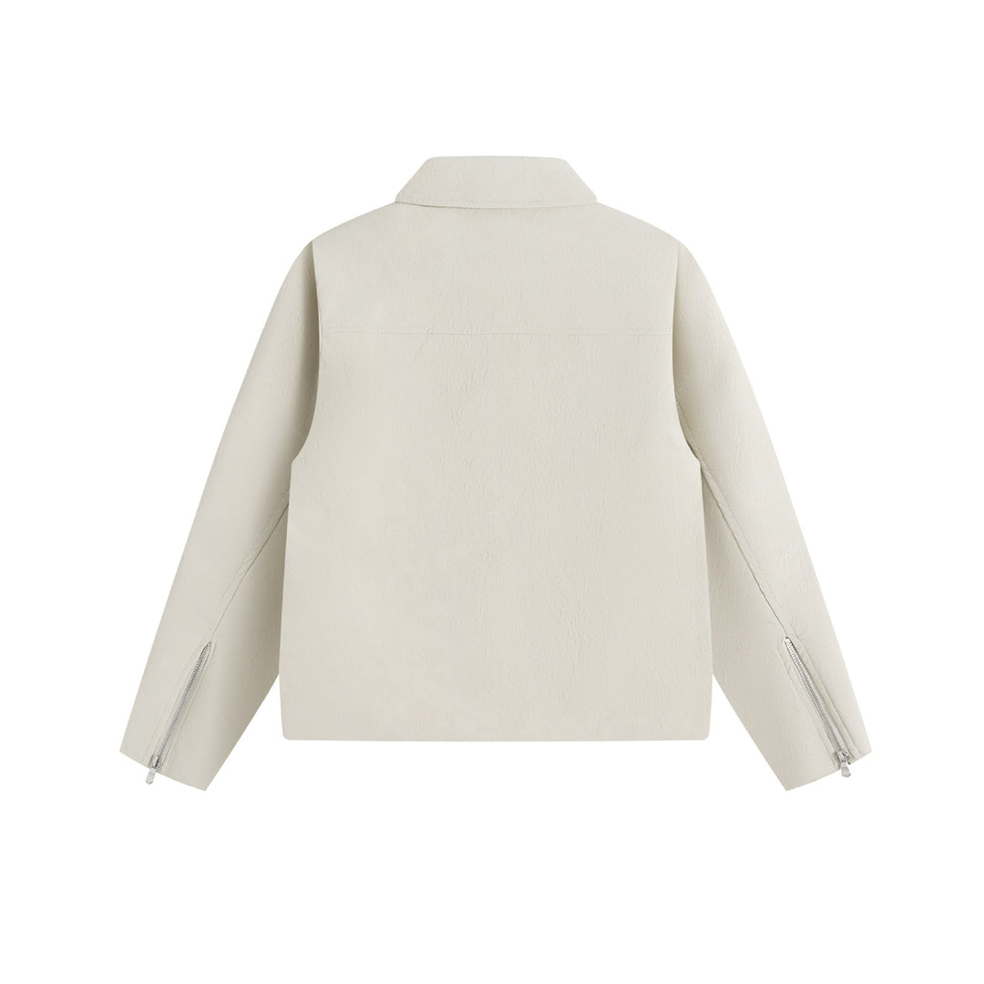 Men's short jacket in suede look with asymmetric front flap and geometric flap pockets.