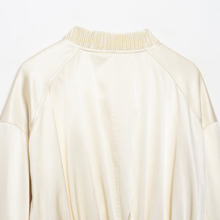 Women's cropped bomber jacket made of vegan leather look with voluminous raglan sleeves and ribbed cuffs.