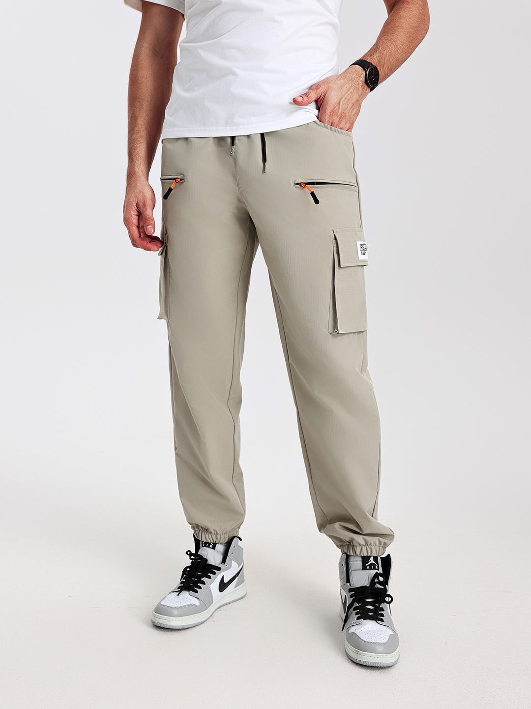 Men's tapered cut utility cargo pants in jogger style with drawstring waistband, zippered pockets & elastic leg cuffs Mune Fashion