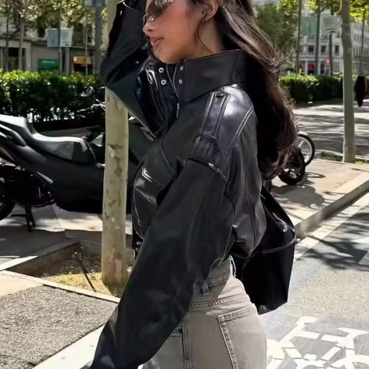 Women Short-Cut Leather Bomber with High Stand Collar, Shoulder Straps and Flap Pockets Mune Fashion