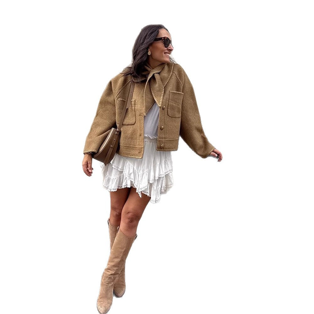 Women's short jacket made of wool blend with a suggested shawl collar, decorative seams, and boxy cropped cut Mune Fashion