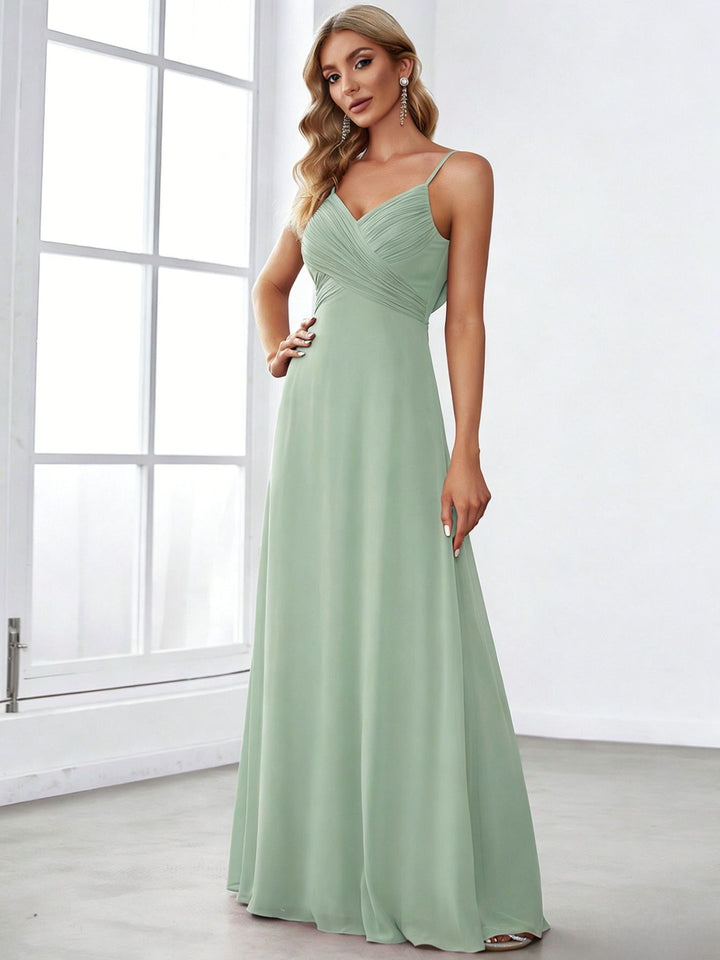 Ladies flowing chiffon evening dress with crossed draping, empire waist and fine spaghetti straps Mune Fashion