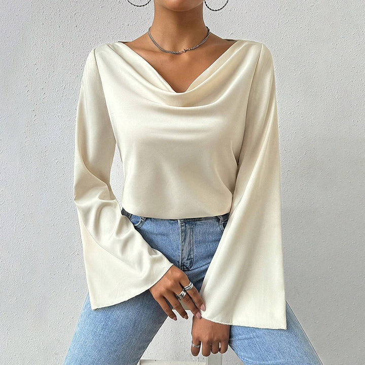 Women's blouse with waterfall neckline, wide trumpet sleeves and flowing satin look.