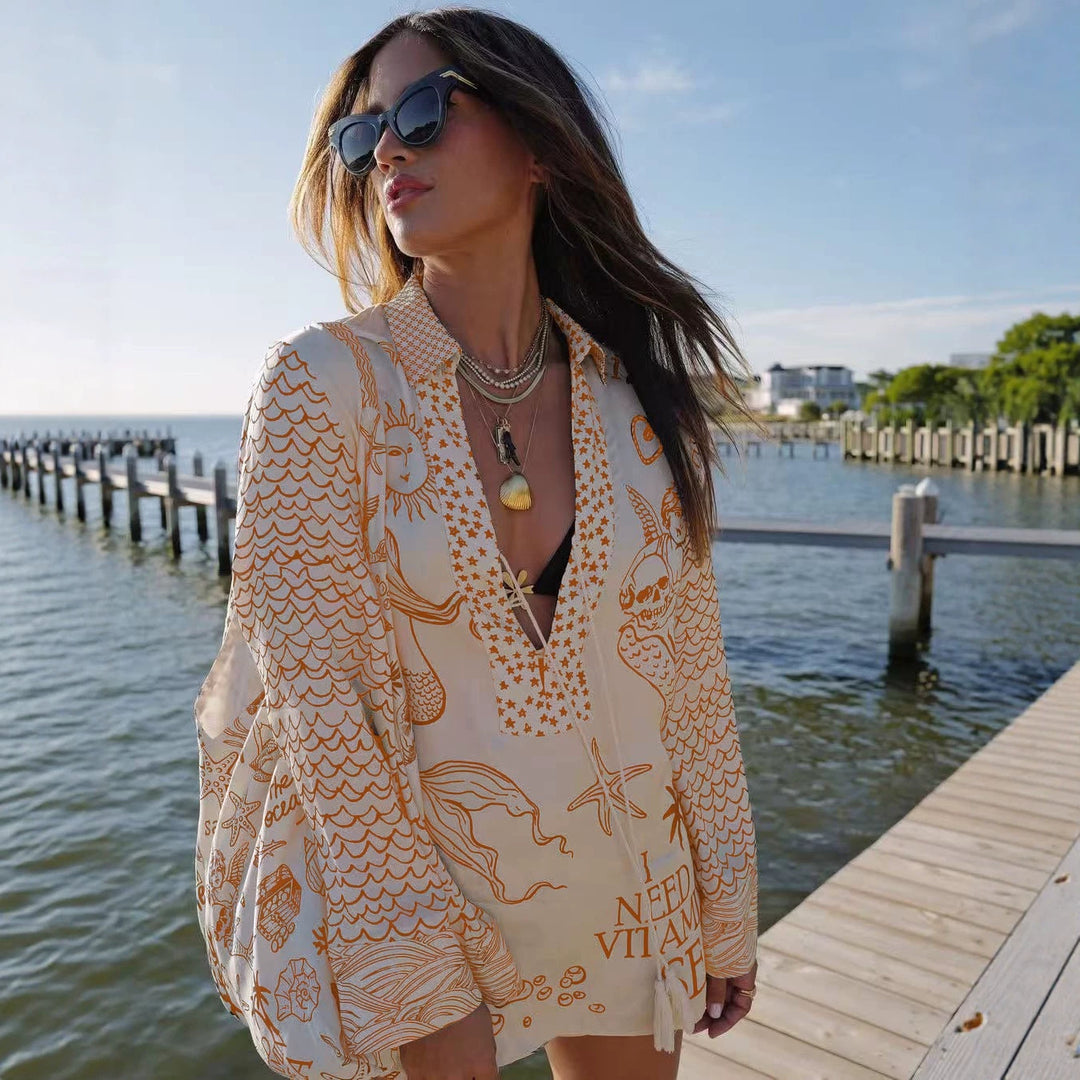Ladies lightweight beach cover-up in tunic form with deep V-neck, tassel closure, and nautical ocean print Mune Fashion