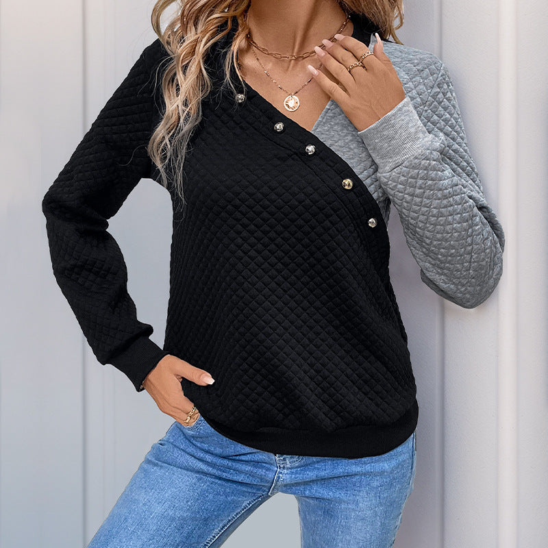 Women’s quilted sweatshirt with asymmetric lapel, decorative press buttons, and color block sleeves Mune Fashion
