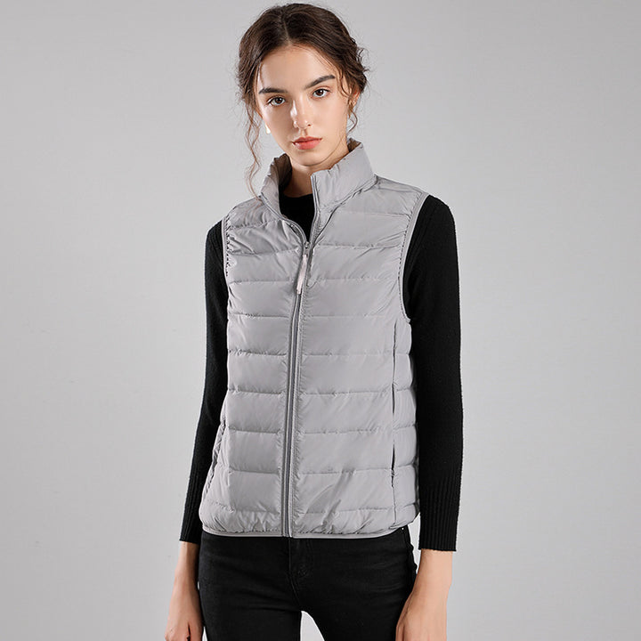 Women's packable quilted vest with flat down look, stand-up collar and side slip pockets Mune Fashion