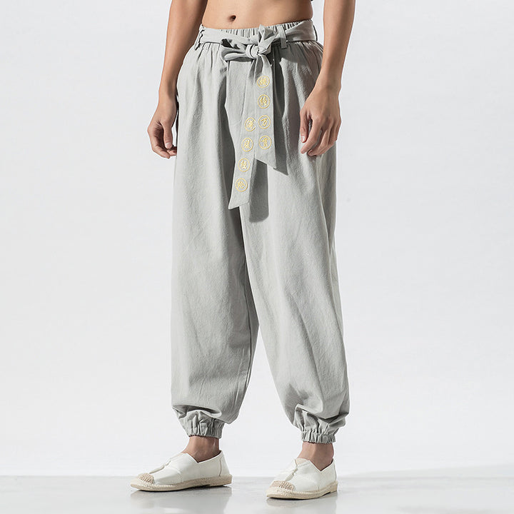 Women's wide linen trousers with drawstring waistband, binding detail, and elastic ankle cuffs Mune Fashion