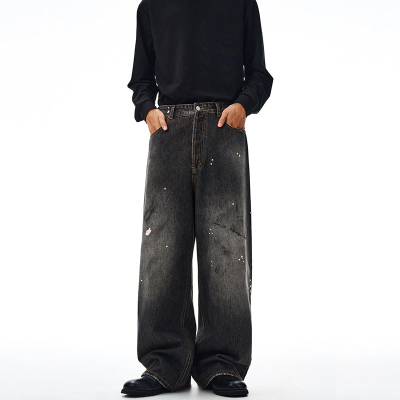 Men's loosely cut denim pants in floor-length baggy style with subtle paint splatter look Mune Fashion