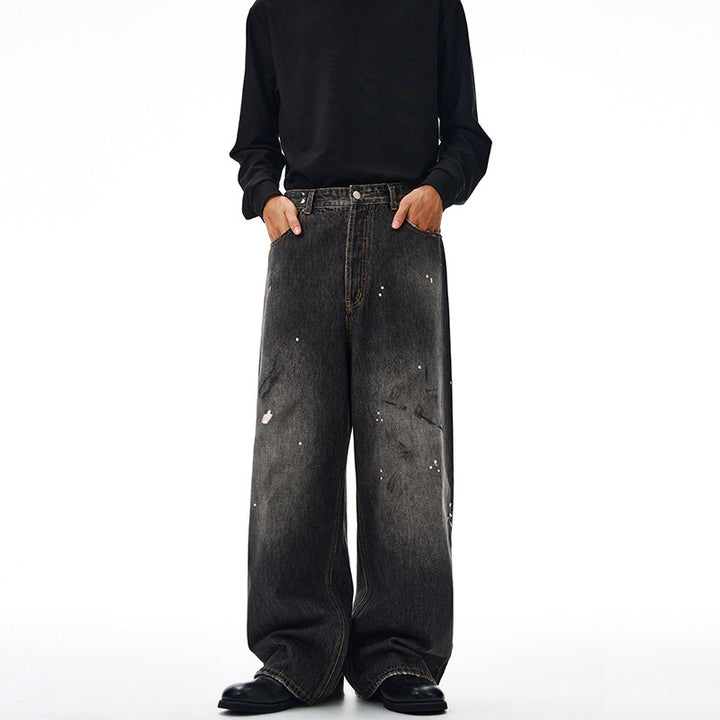 Men's loosely cut denim pants in floor-length baggy style with subtle paint splatter look Mune Fashion