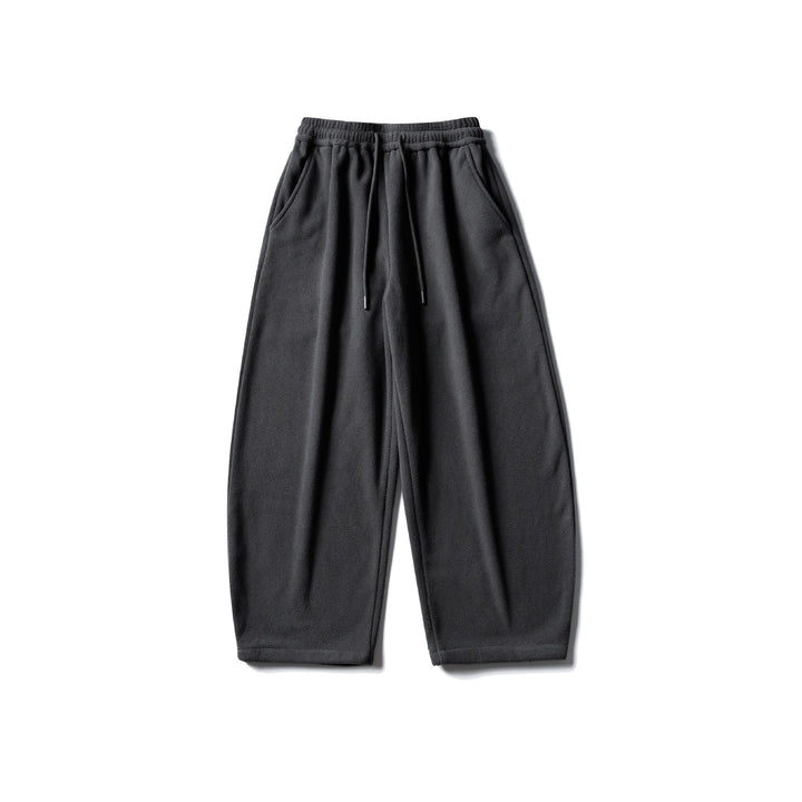 Unisex fleece jogging pants with elastic drawstring waistband, side pockets and tapered leg Mune Fashion