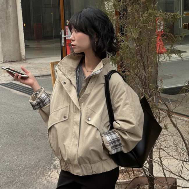 Women’s short bomber jacket with stand-up collar, chin strap, and checkered sleeve lining Mune Fashion