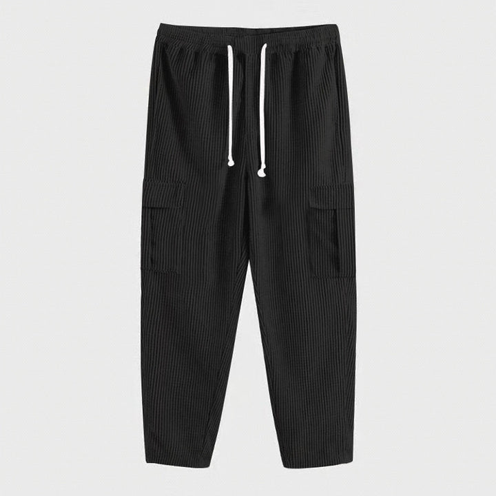 Men's corduroy cargo jogging pants with elastic drawstring waistband, flap pockets, and tapered leg Mune Fashion