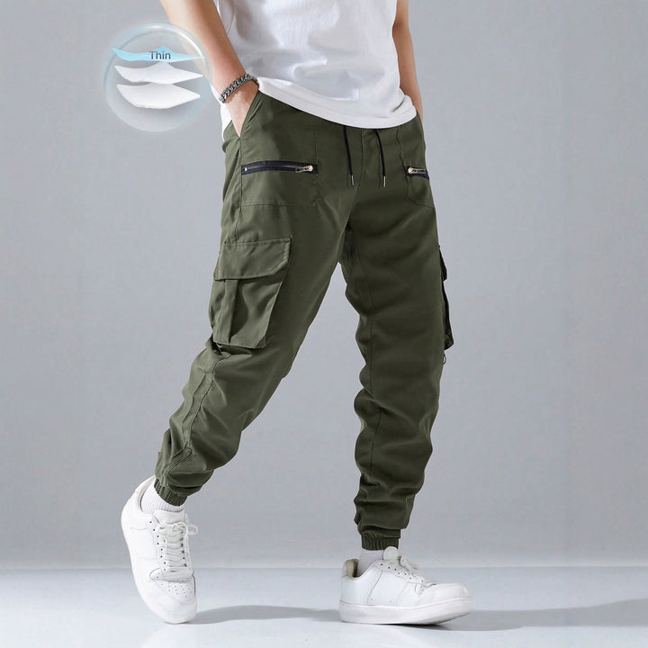 Men's slim cargo joggers with multiple zippered pockets, elastic ankle cuff, and drawstring Mune Fashion