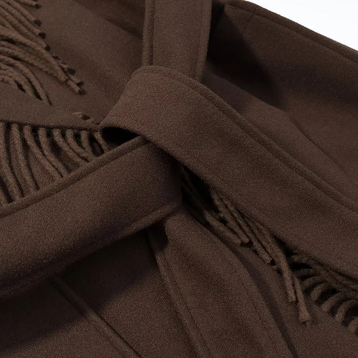 Ladies long fringed coat with voluminous shawl collar, waist belt and patch pockets Mune Fashion
