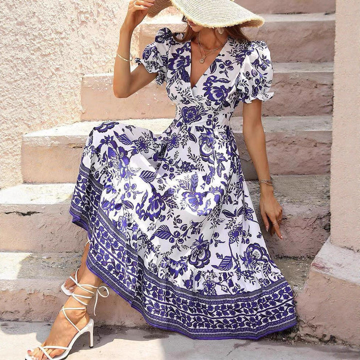 Women’s boho-inspired maxi dress with gathered empire waist, short puff sleeves, and decorative border print Mune Fashion